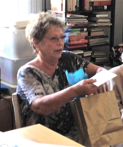 Marsha Millman opening gift at her 2014-Last meeting as president of the Daughters